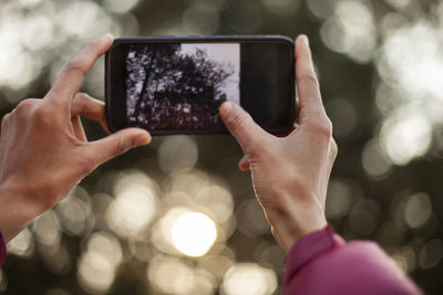 Midsection of person using mobile phone