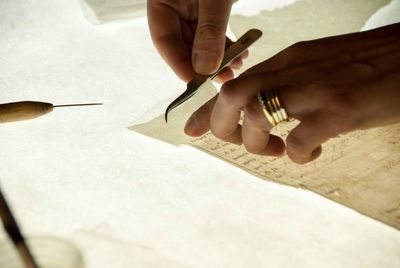 Cropped image of woman working on papers at workshop