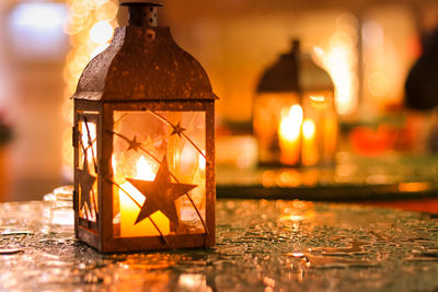 Close-up of illuminated lantern on table