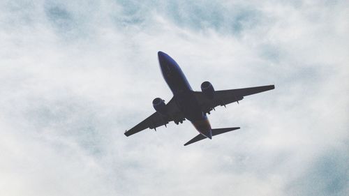 Low angle view of airplane flying in sky