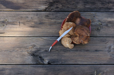 High angle view of dead leaves on wooden table