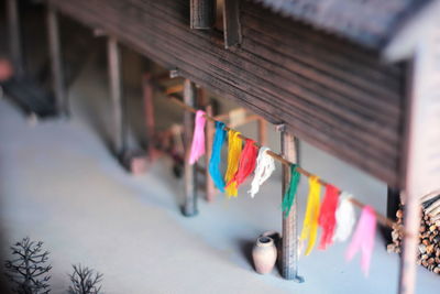 Close-up of multi colored flags hanging on railing
