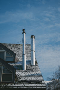 Low angle view of building against cloudy sky