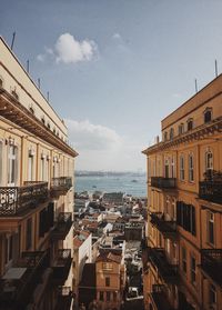 Panoramic view of city by sea against sky