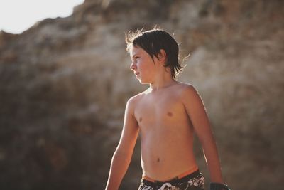 Portrait of shirtless boy in water