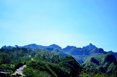 Scenic view of mountains against clear blue sky
