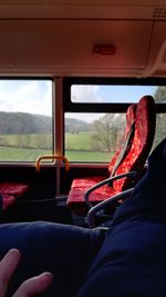 Midsection of person sitting in bus