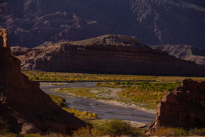 Scenic view of rock formation on land against mountains