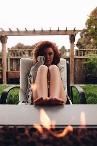 Portrait of young woman sitting outdoors