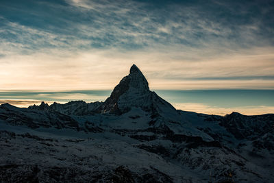 Scenic view of dramatic landscape against cloudy sky