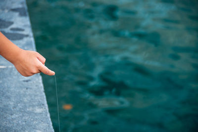 Midsection of person holding sea against blurred background