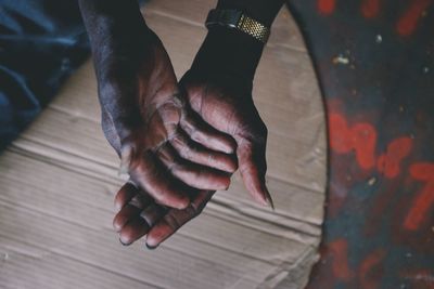 Close-up of hand on wooden wall