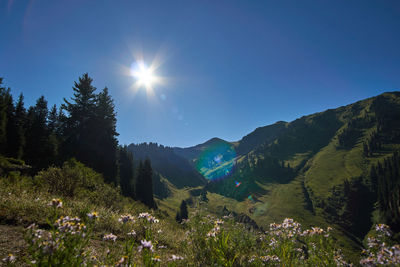 Scenic view of mountains against sky on sunny day