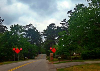 Country road against cloudy sky