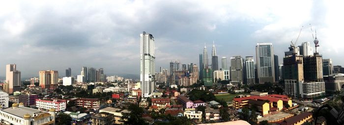 Panoramic view of modern buildings in city against sky