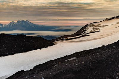 Scenic view of snowcapped mountains against sky during sunset