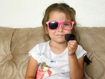 Portrait of girl wearing broken sunglasses