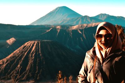 Portrait of man wearing sunglasses against mountain range