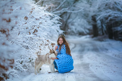 Woman with dog in snow