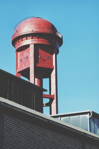 Low angle view of water tower against clear sky