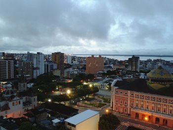 View of cityscape against cloudy sky