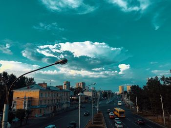 Cars on street against sky