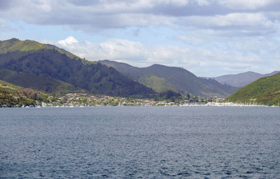 Scenic view of sea and mountains against sky