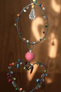 Close-up of decoration hanging on wood
