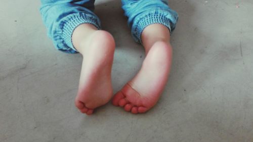 Low section of child sitting on floor