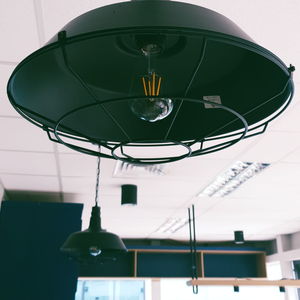 Low angle view of illuminated pendant lights hanging from ceiling