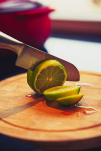 Close-up of a chef cutting a lemon with a sharp knife 