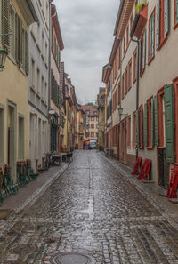 Street amidst buildings in city against sky