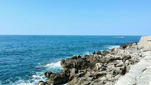 Scenic view of sea against clear blue sky