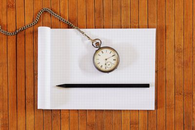 Directly above shot of clock on table