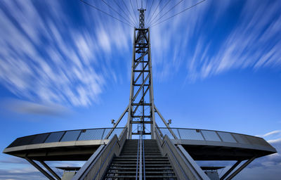 Low angle view of electricity pylon against sky