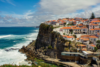 Panoramic view of sea and buildings against sky