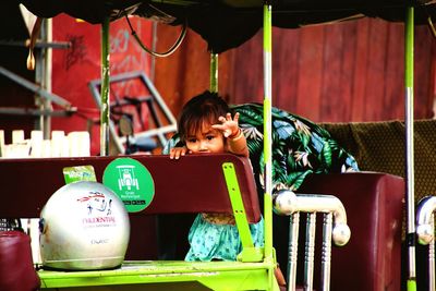 Girl sitting in amusement park