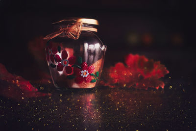 Close-up of jar with glitter on table