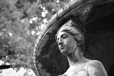 Low angle view of old sculpture at cemetery