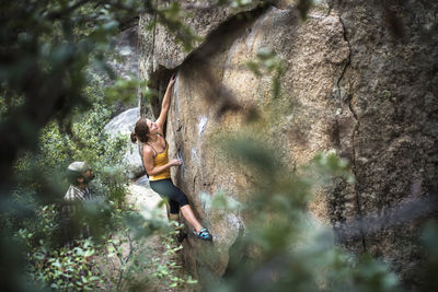 High angle view of woman rock climbing