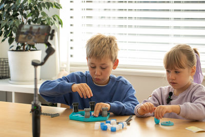 Boy playing with toy blocks at home