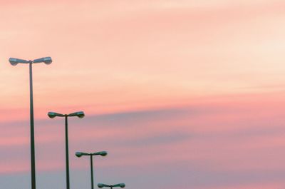 Low angle view of street light against orange sky