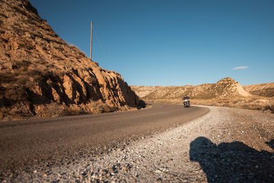 Man riding motorcycle against sky