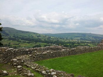 Scenic view of mountains against cloudy sky