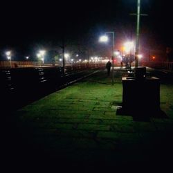 Man in illuminated city at night