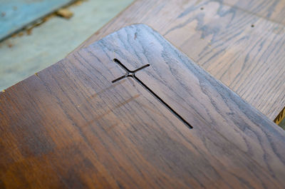 Cross on wooden surface