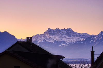 Snowcapped mountains against clear sky during winter