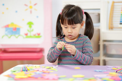 Young girl making craft for homeschooling