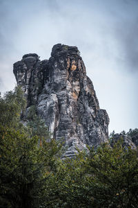 Low angle view of rock formations against sky