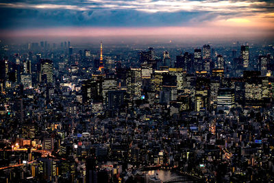 Aerial view of illuminated cityscape against sky